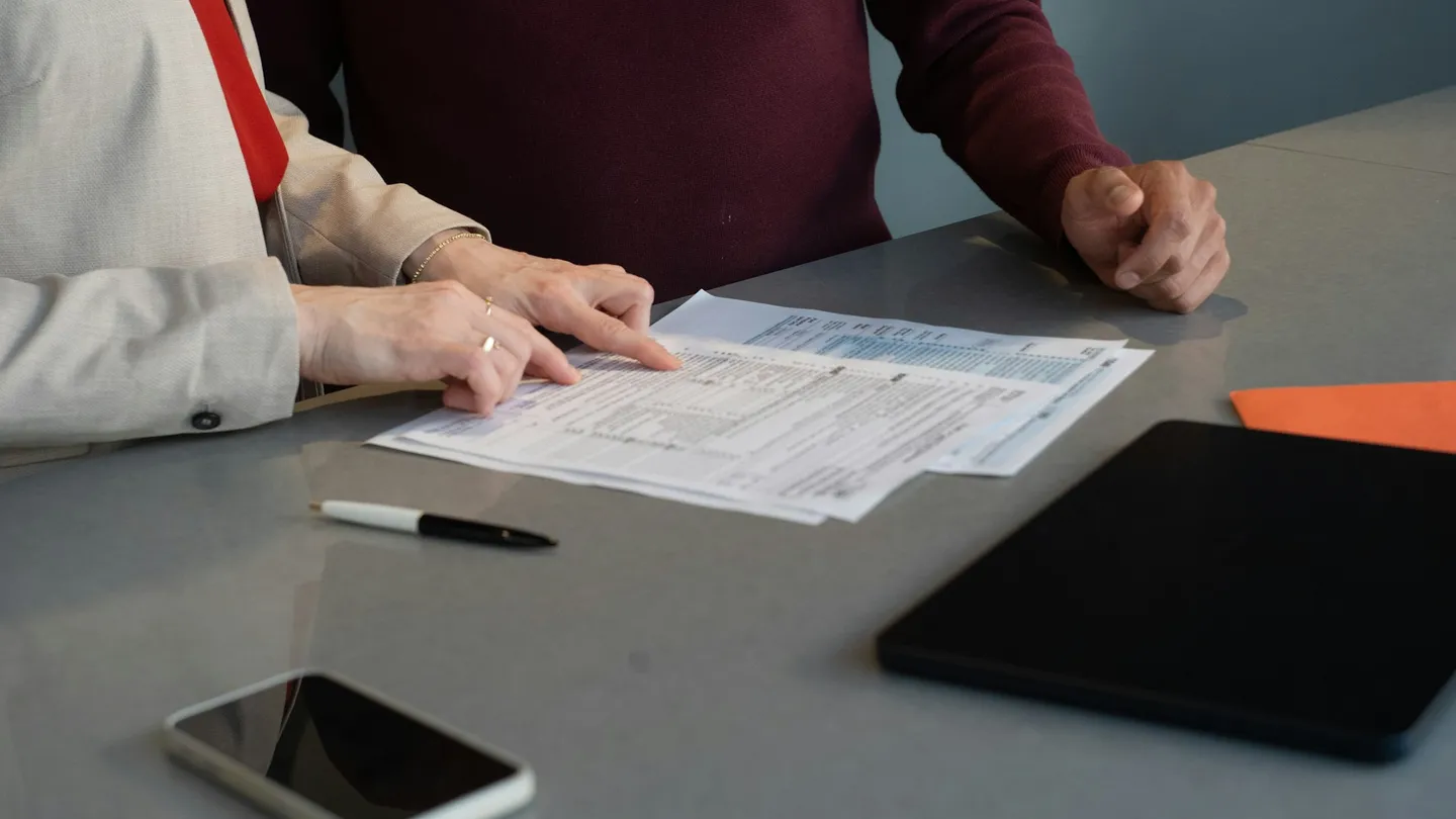 Two people reviewing documents at a table