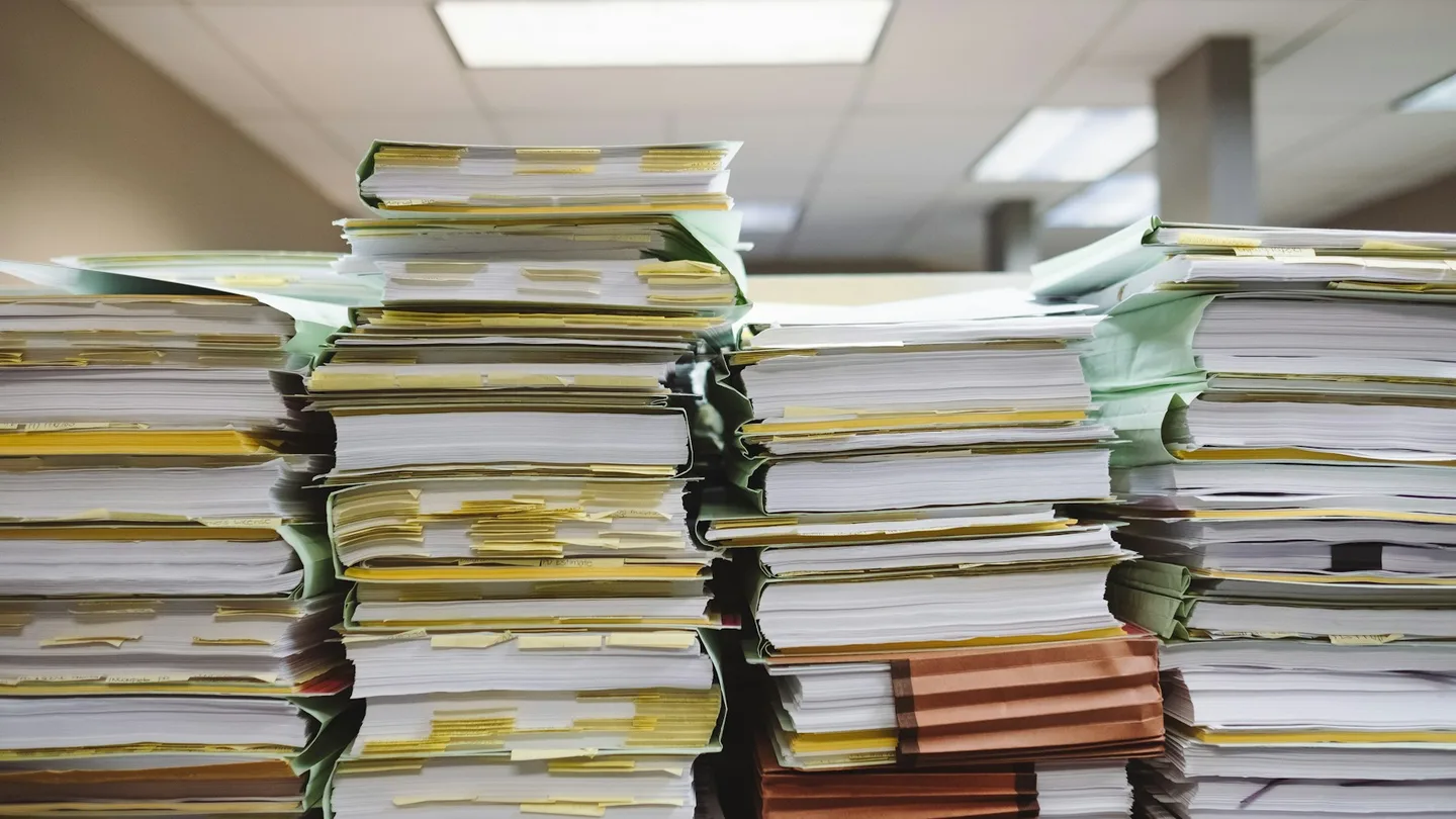 stacks of paper documents and file folders