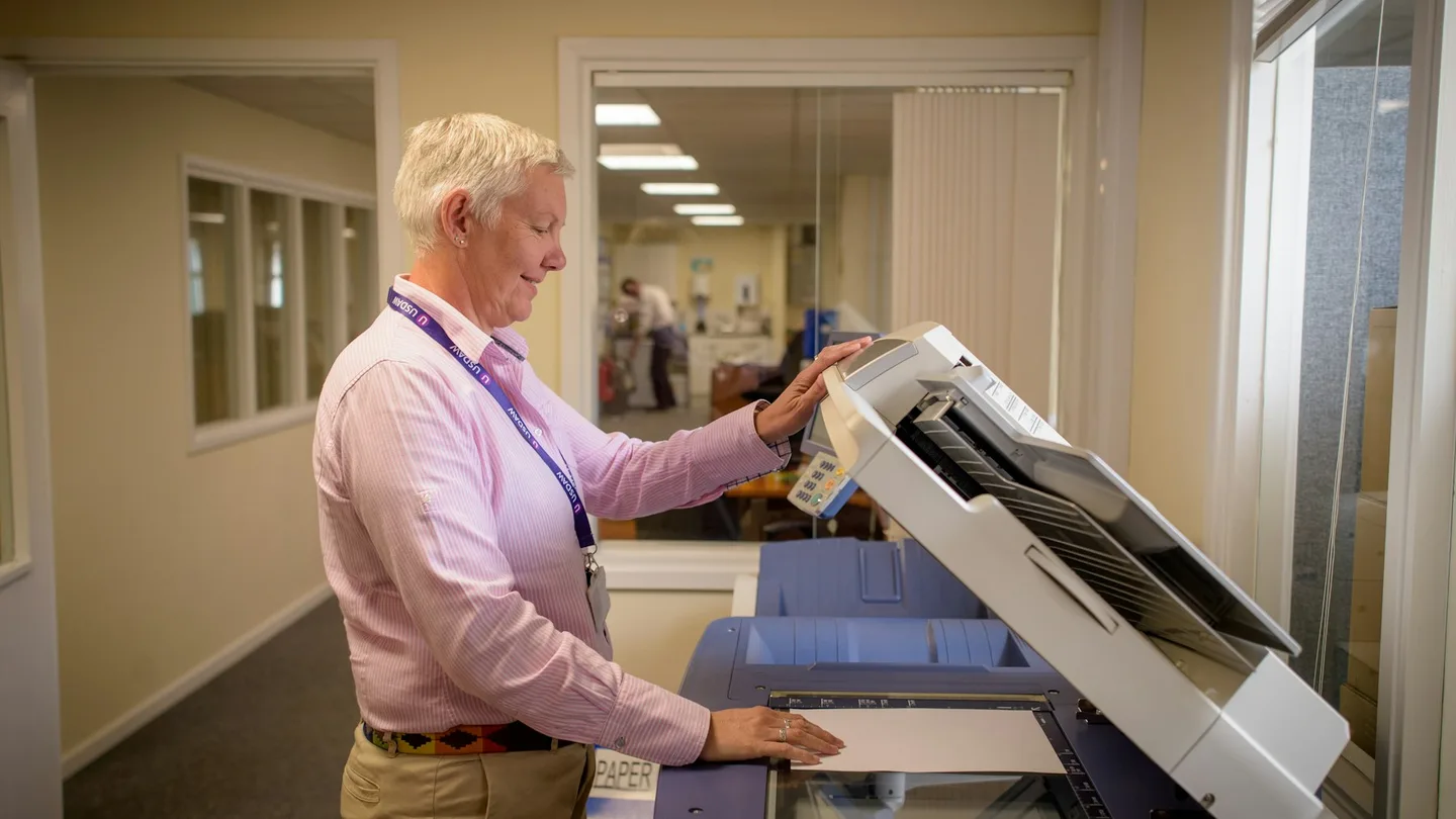 A person operating a document scanner