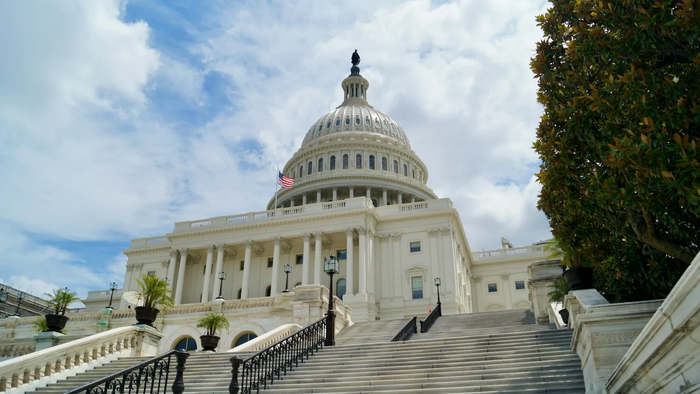 The United States Capitol beneath a cloudy sky