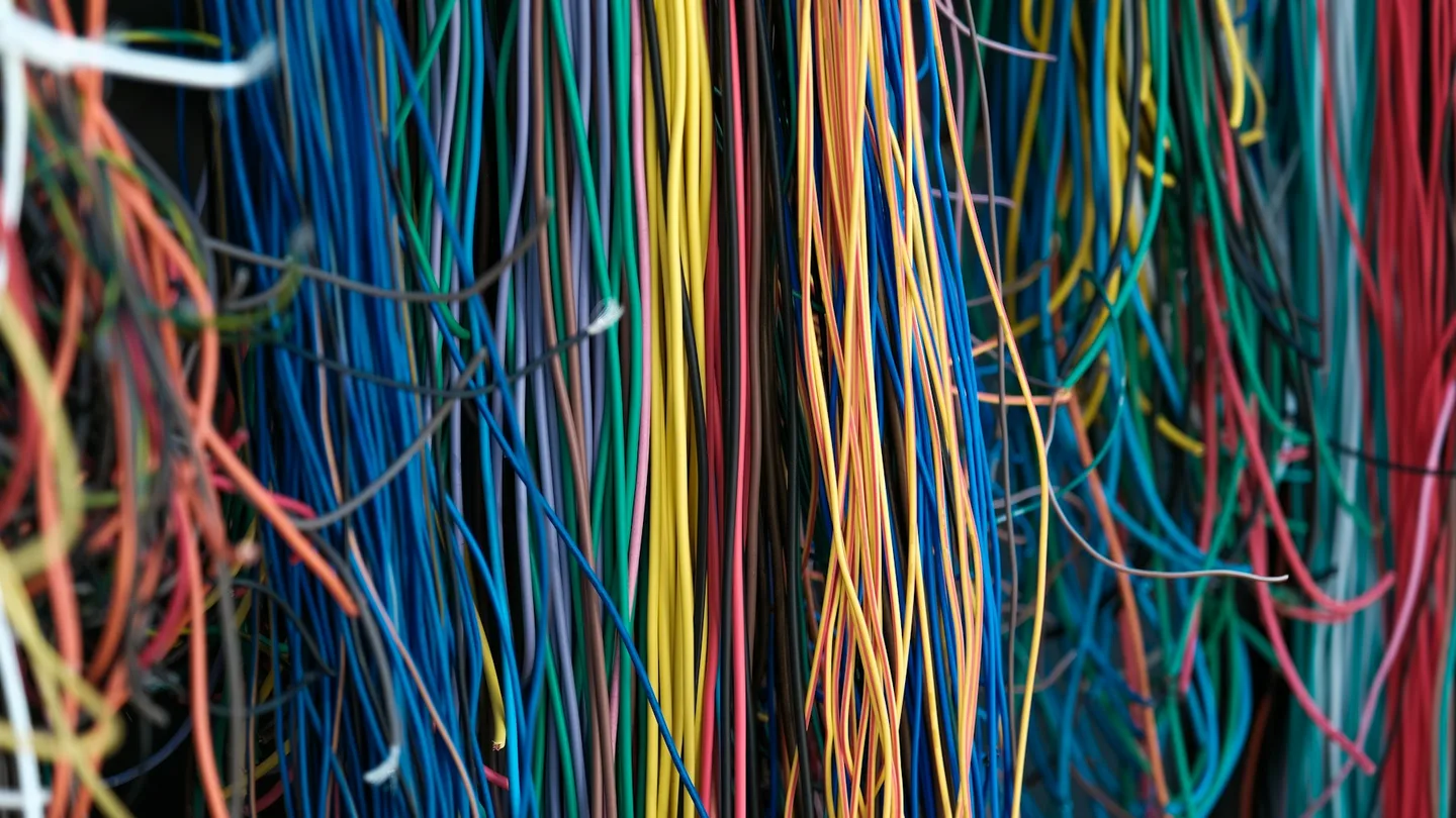 Multicoloured cables connected to telecommunications equipment