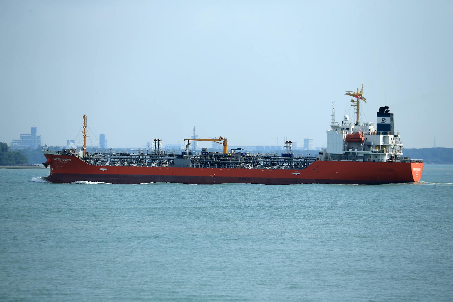 Oil tanker in commercial harbor representing Strait of Hormuz shipping