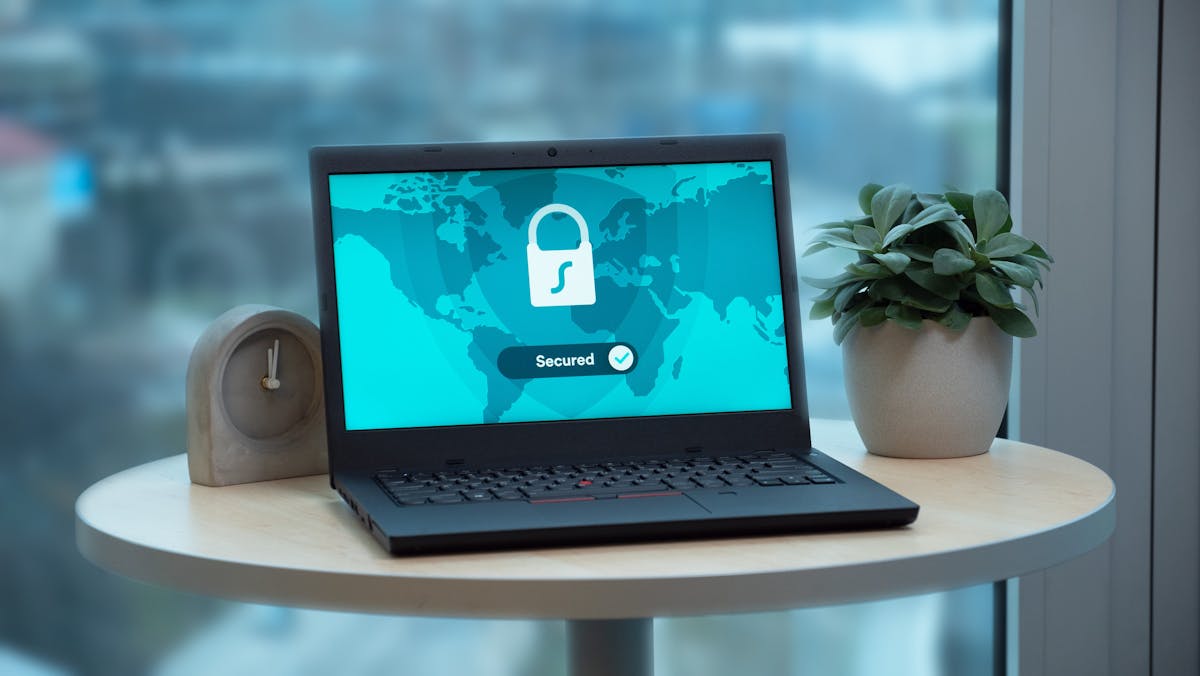 Laptop with digital lock representing cryptographic trust boundaries and agent permissions